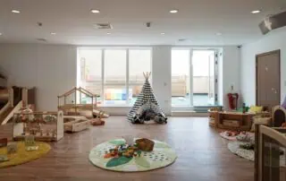 5-1-1 Bright and spacious indoor play area at Monkey Puzzle Day Nursery Stoke Newington, featuring engaging toys, soft rugs, and child-friendly furniture, perfect for early childhood development.