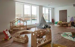 8-1 Bright indoor play area at Monkey Puzzle Day Nursery Stoke Newington with natural light, wooden toys, and engaging activities for young children.