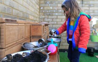 exploring outside in our mud kitchen
