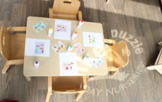 Preschool Monkey Puzzle Stoke Newington Colorful alphabet and language learning materials on a children's table at Monkey Puzzle Day Nursery Stoke Newington.