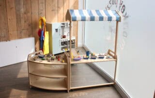Preschool Monkey Puzzle Stoke Newington Bright wooden toy kitchen and play food set in Monkey Puzzle Day Nursery Stoke Newington. Ideal for early childhood development and imaginative play in a safe nursery environment.